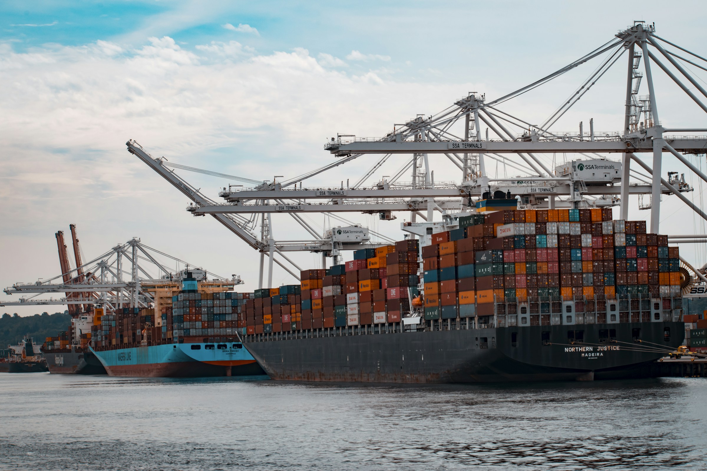 A busy container port with freight cranes and cargo ready for transport